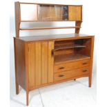 A retro mid century teak wood sideboard credenza. Raised on shaped supports having a series of