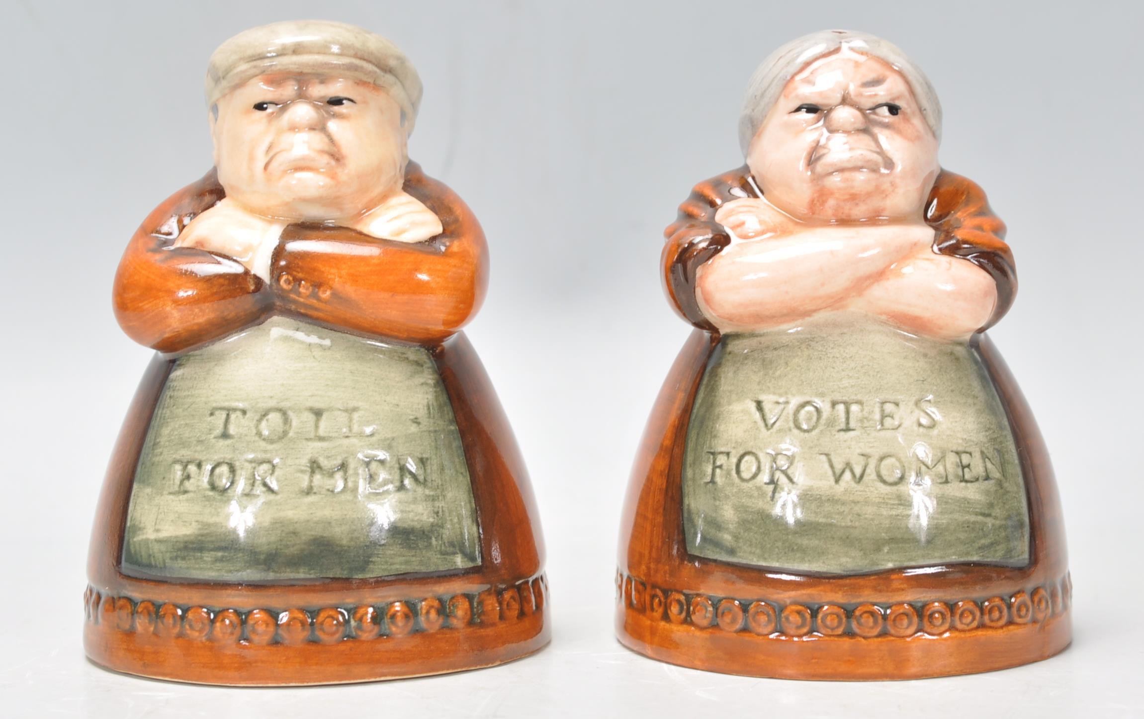 A pair of Royal Doulton salt and pepper pots entitled 'Votes for Women' and 'Toil for Men', D7066