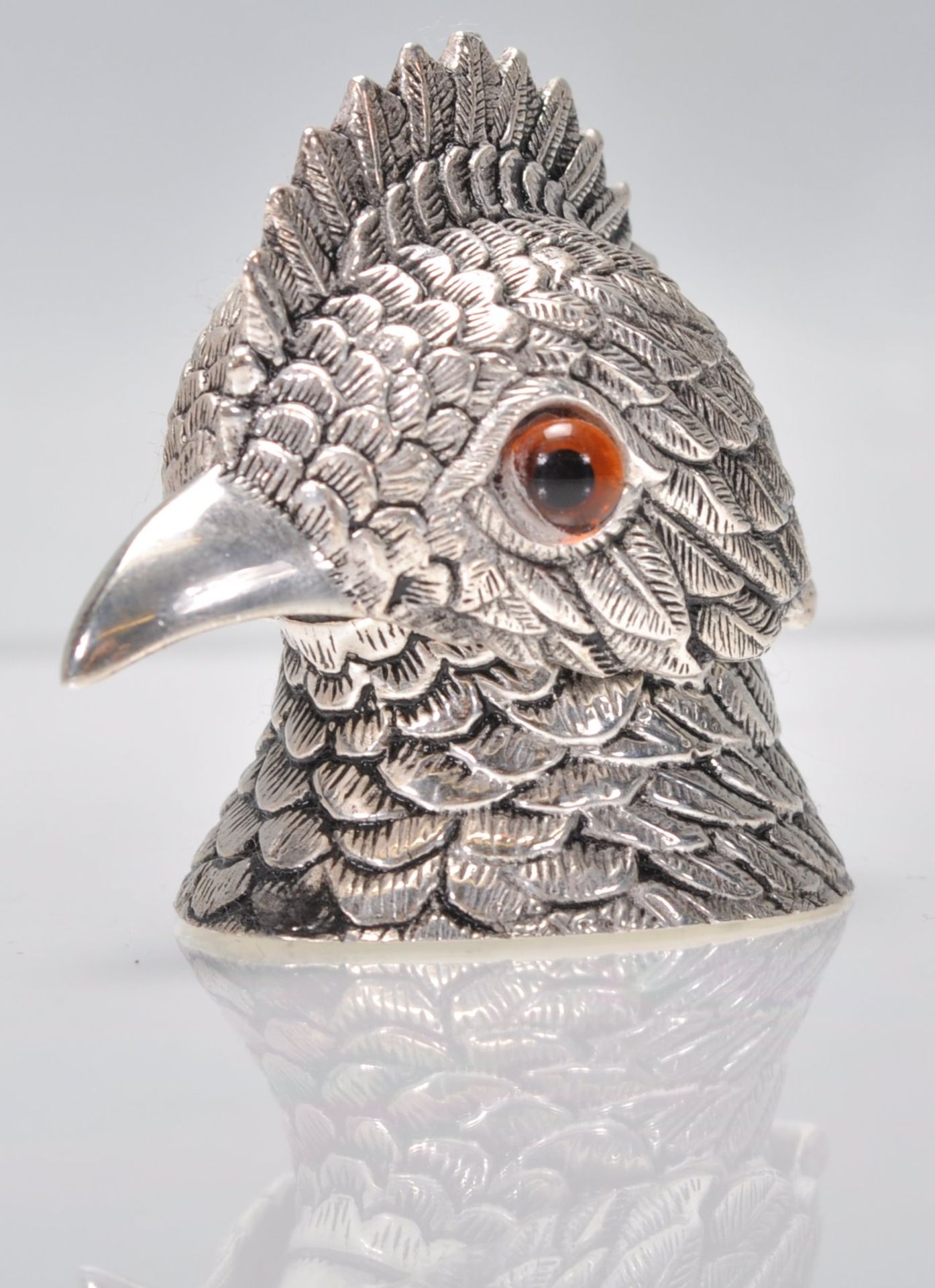 An unusual silver white metal inkwell in the form of a bird having detailed feather decoration being