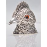 An unusual silver white metal inkwell in the form of a bird having detailed feather decoration being