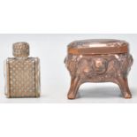 A small copper trinket / pill souvenir box having embossed decoration with a landscape pane to the