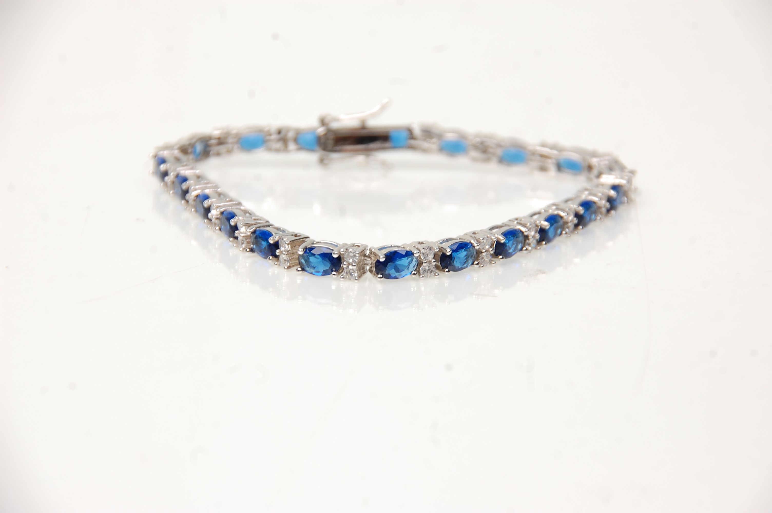 A stamped 925 silver tennis bracelet being set with oval cut blue stones with round cut white - Image 3 of 5