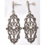 A pair of stamped 925 silver ladies drop earrings  having pierced decoration set with marcasites and