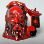 A Royal Doulton ceramic flambe Confucius character jug, having a red glaze. No.D7003, limited