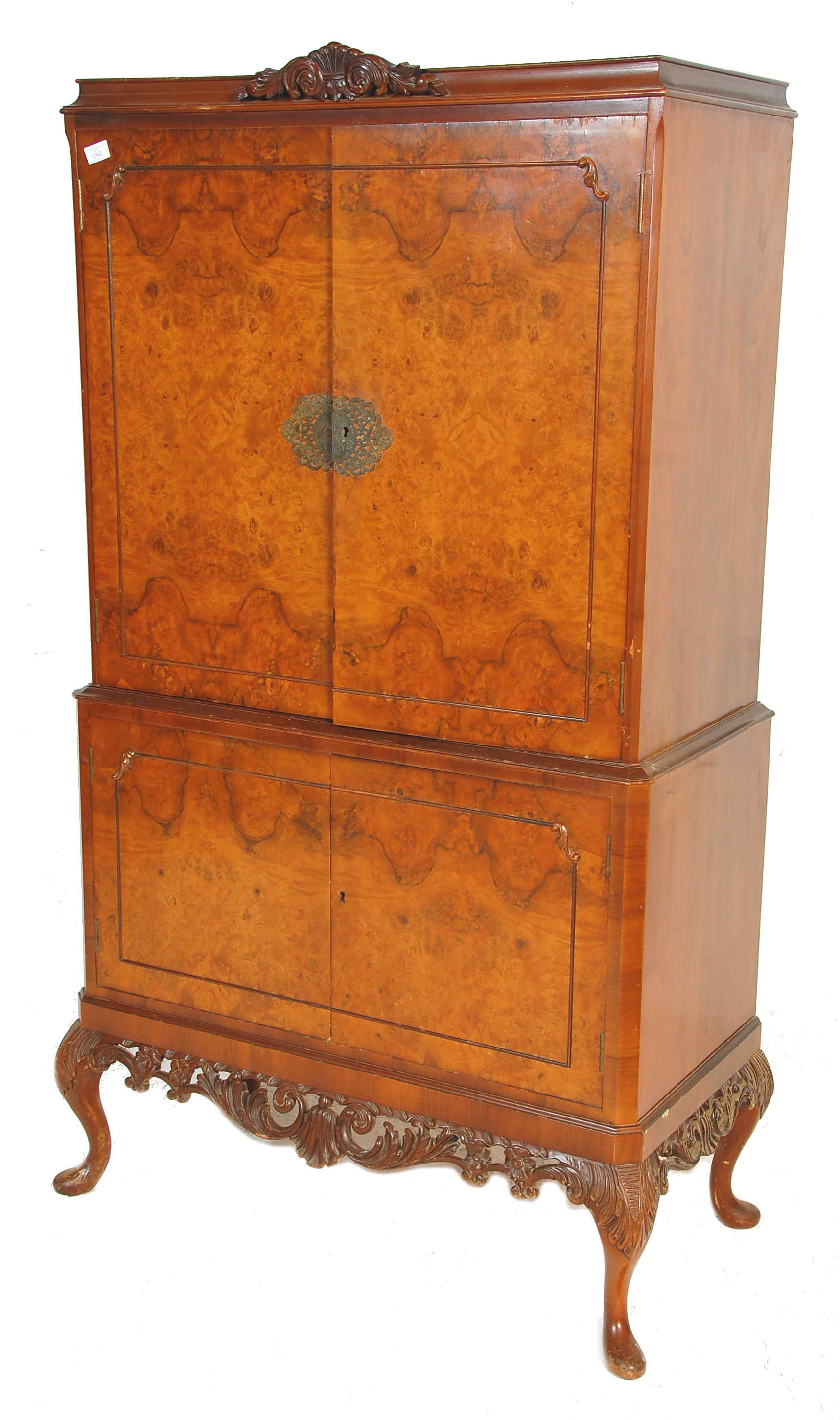 An early 20th Century Queen Anne style walnut drinks / cocktail cabinet of two tiered form, the