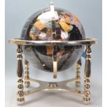 A vintage 20th century large terrestrial globe having semi precious stone inlay. Black stone