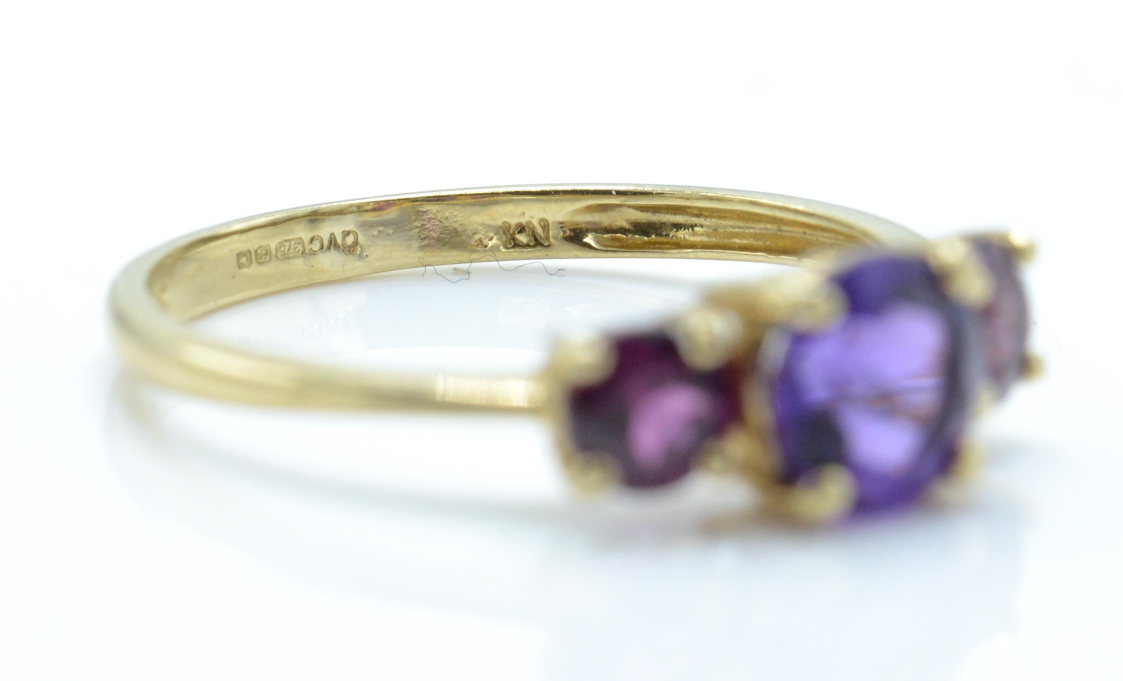 A 9ct gold Birmingham hallmarked 3 stone amethyst ring. The 3 round mixed cut amethysts in 4 prong - Image 4 of 4