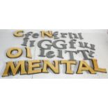 A collection of vintage wooden shop advertising wall mounting cut out letters most being a black