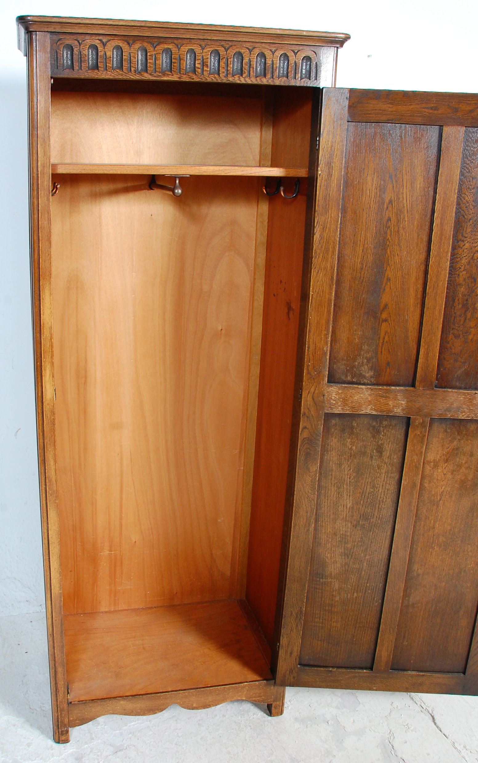 A 1930's oak Art Deco wardrobe having a singe four panelled door with carved graphic decoration to - Image 4 of 5