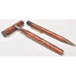 A pair of vintage early plastic writing pens to include a fountain pen and a mechanical ball point