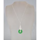 A stamped 925 silver pendant necklace having a triangular pendant set with white stones and a