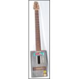 A 20th Century retro African electric guitar, the body constructed from a vintage oil can having