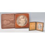 Two vintage early 20th Century leather bound photo frames to include a square cased example with