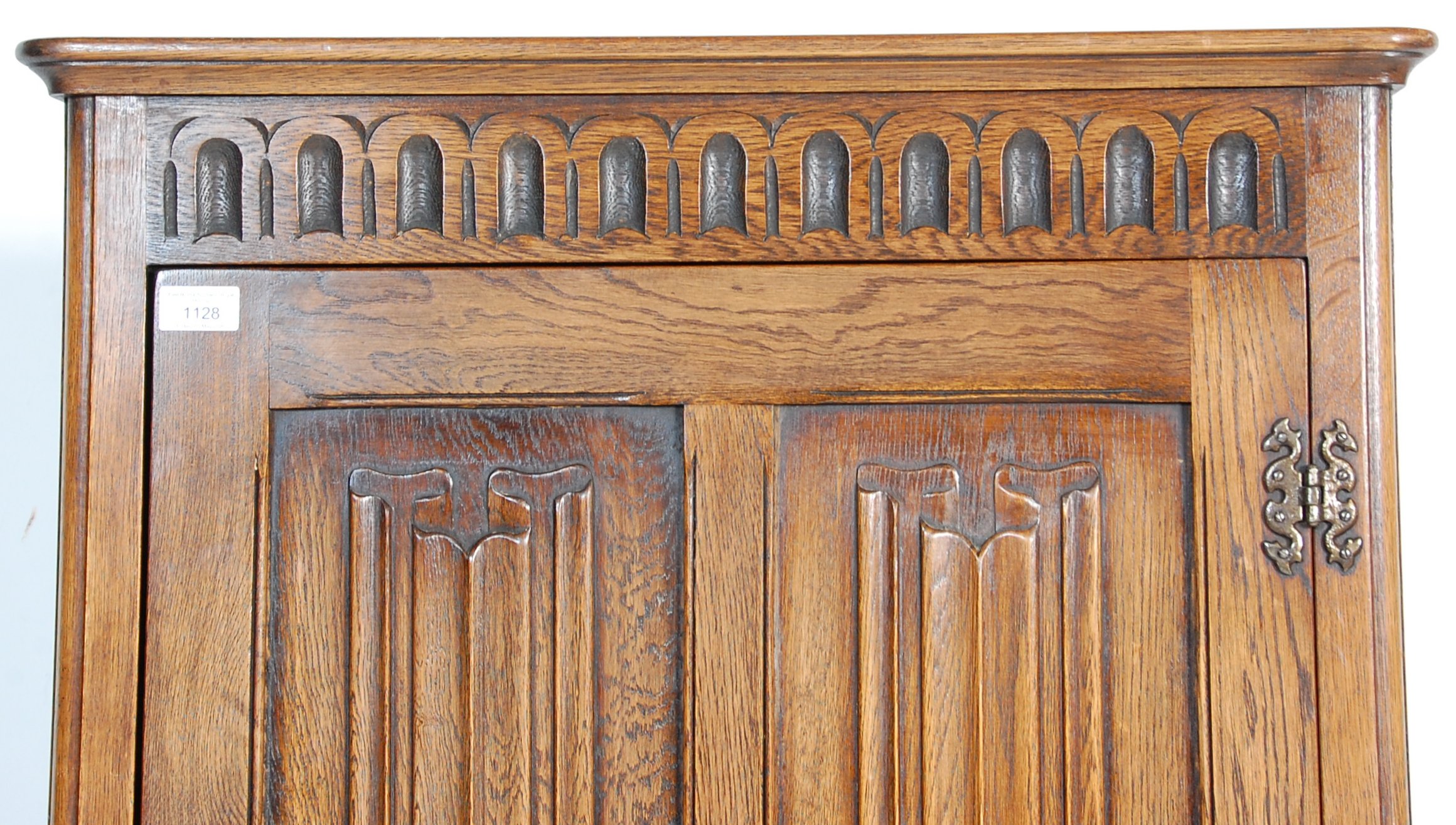 A 1930's oak Art Deco wardrobe having a singe four panelled door with carved graphic decoration to - Image 3 of 5