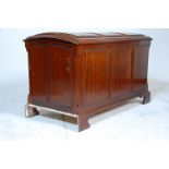An early 20th century mahogany dome topped coffer chest having three fielded panels to the front and