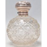 A 19th Century Victorian cut glass dressing table scent bottle of bulbous form having a silver