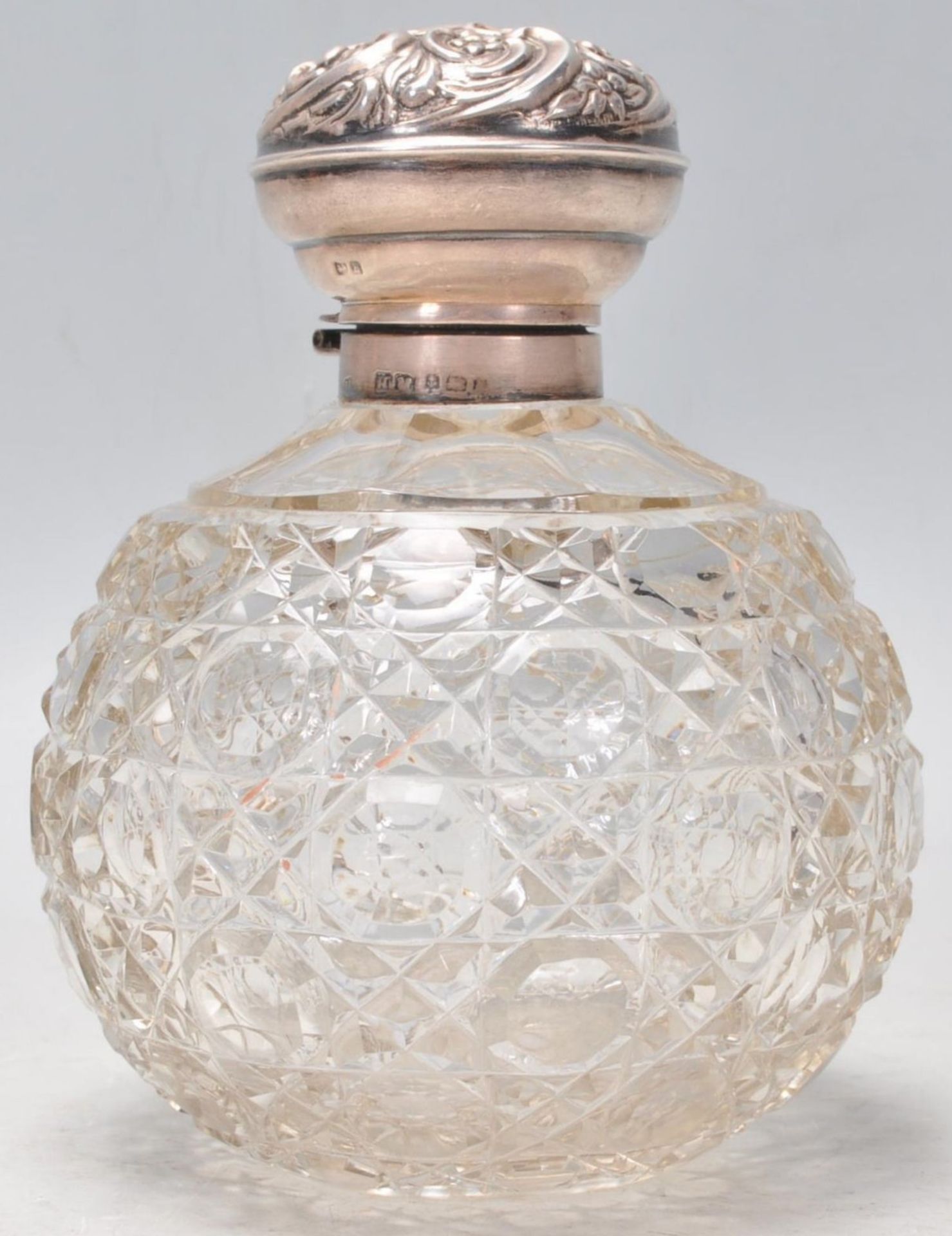 A 19th Century Victorian cut glass dressing table scent bottle of bulbous form having a silver