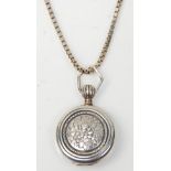A stamped 925 silver locket of round form having repousse floral decoration on a stamped 925
