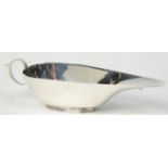 An early 20th Century Art Deco silver hallmarked sauce boat of stylish form. Hallmarked for