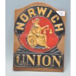 A vintage 20th Century tin plaque for Norwich Union having black and red ground with gilt