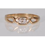 jA yellow gold crossover design ring set with two round cut diamonds. Gold unmarked. Weight 1.8g.