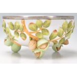 A 20th century Musterschutz porcelain fruit bowl with white metal rim, the bowl embellished with