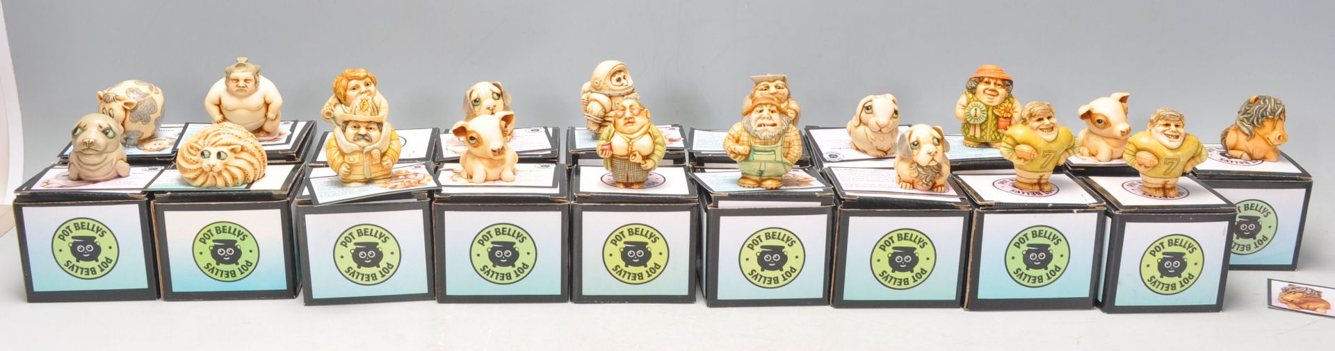 A good collection nineteen Pot Bellys carved resin figures to include Fireman, Pig, Dog, Cow,