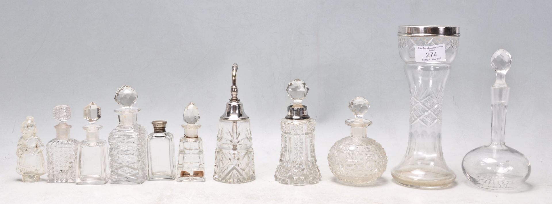 A collection of antique and vintage cut glass perfume / scent bottles to include a 1920's Art Deco