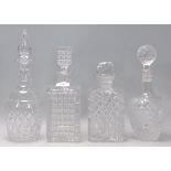 A group of four 20th Century cut crystal decanters two of square form and two of bottle form