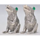 A pair of 925 silver condiments in the form of frogs having textures backs set with green stone