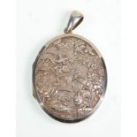 A 19th Century Victorian unmarked silver locket having finely carved Japanese scene panel front.