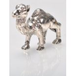 A stamped sterling silver figurine in the form of a camel with embossed detailing. Weight 16.8g.