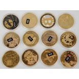 A mixed group of twelve plated coin medallions to include 4x Remember Sept 11 coins, 2x Bitcoin