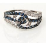 A stamped 14ct white gold knot ring set with diamonds and sapphires. Weight 3.8g. Size L.