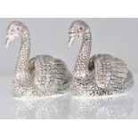 A pair of stamped 925 silver condiments in the form of swans having raised details and set with