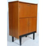 A mid century retro teak wood Danish inspired bureau desk. Raised on tapering legs with a double