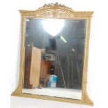 An antique early 19th Century regency wall mirror having a gilt frame with moulded gilt decoration