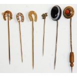 A group of six vintage ladies stick pins to include a 9ct gold horseshoe and crop example and two