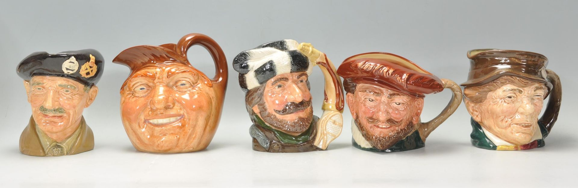A group of five Royal Doulton character jugs to include The Trapper D6609, Monty D6202, Paddy, and
