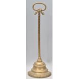 A late 19th Century Victorian brass door stop having a brass rope handle and demi lune base.