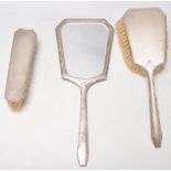 A silver hallmarked 1940's silver dressing table set to include a mirror, hair brush and clothes