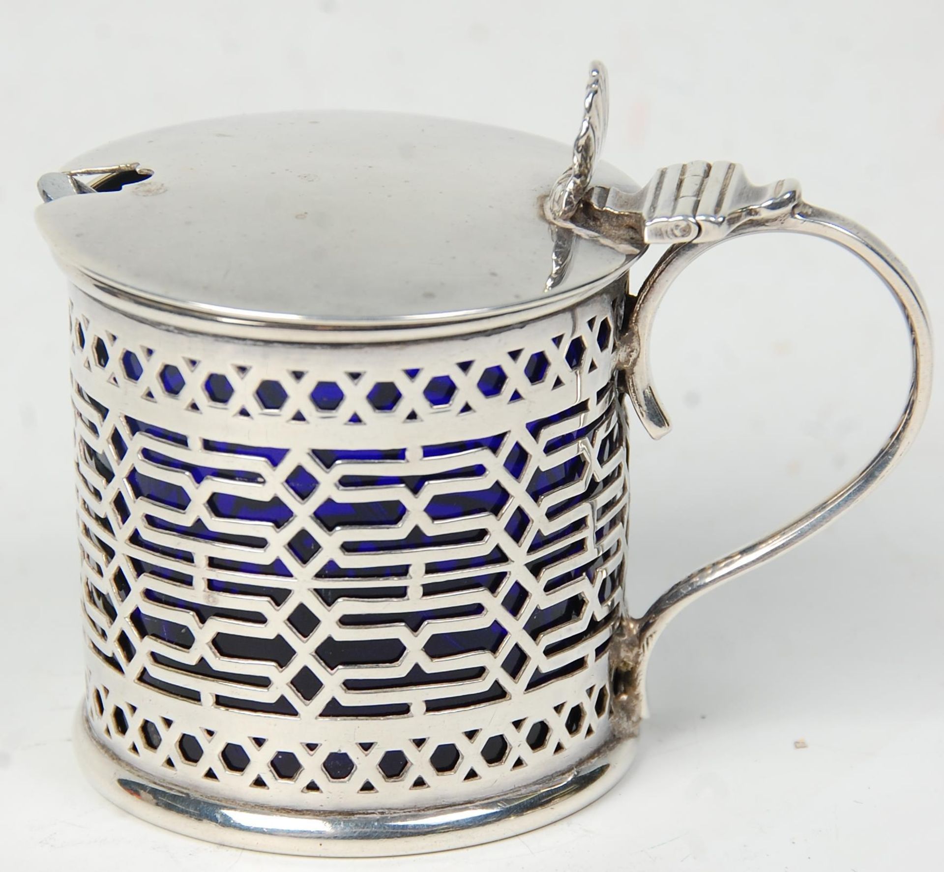 A decorative 19th Century Victorian silver hallmarked mustard pot having fret pierced decoration