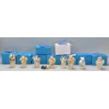 A collection of ten Adam Binder animals related netsuke style resin figurines to include giraffe,