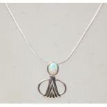 A stamped sterling silver pendant necklace having a snake chain with a Art Nouveau style pendant set