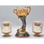 A garniture of three late 19th Century majolica vessels / vases to include a German cornucopia