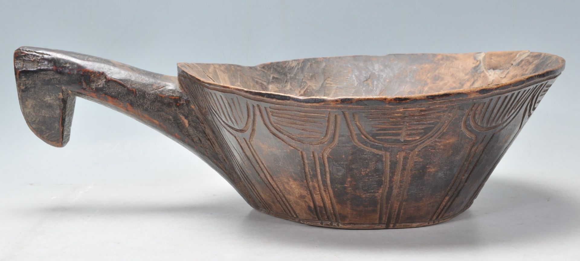 A antique African carved hardwood tribal bowl of conical form having a large carved handle to one - Bild 3 aus 6