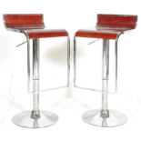 A good pair of retro style chrome bar / breakfast stools raised on round bases with drop down