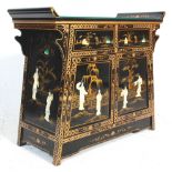 A 20th Century Chinese lacquered sideboard cupboard having a two drawers with twin cupboards below