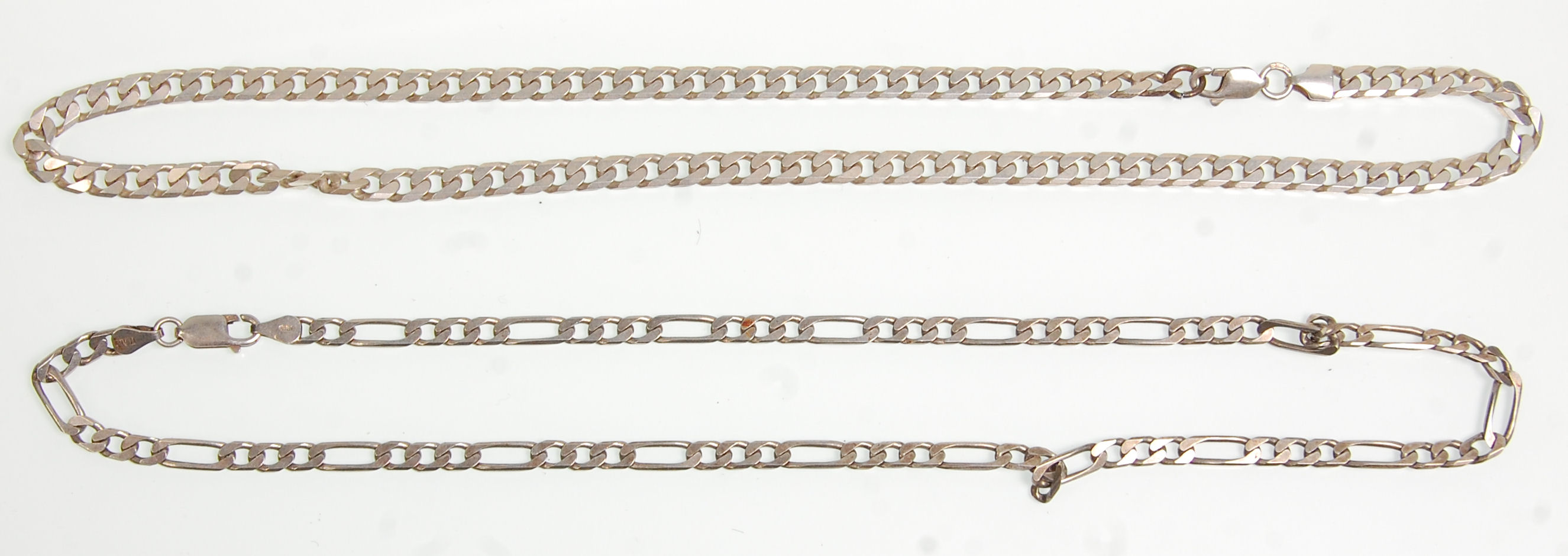 Two silver flat link necklace chains, one being a Figaro example with both having a lobster clasp.