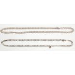 Two silver flat link necklace chains, one being a Figaro example with both having a lobster clasp.